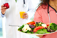A nurse serving a healthy salad A nurse serving a healthy salad